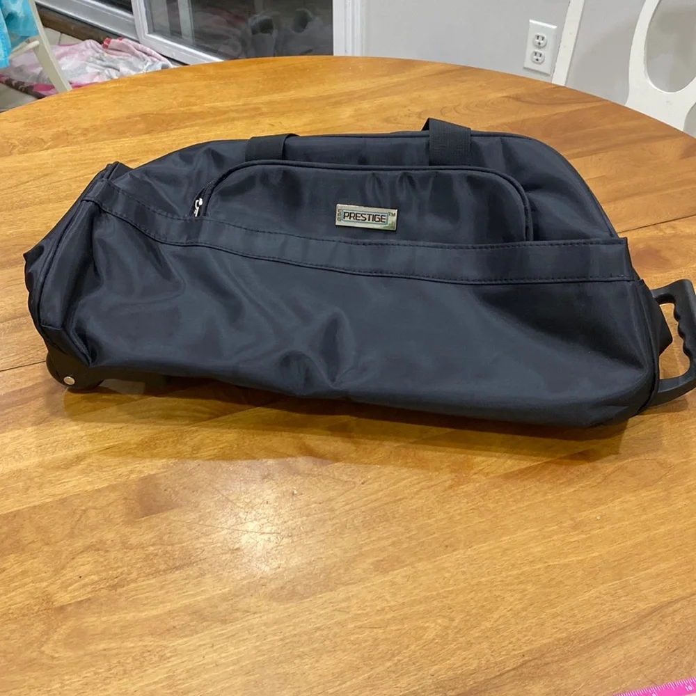 NWOT. Nylon rolling carry-on bag.